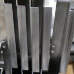 Thin sheet metal component with intricate angles and an grain finish